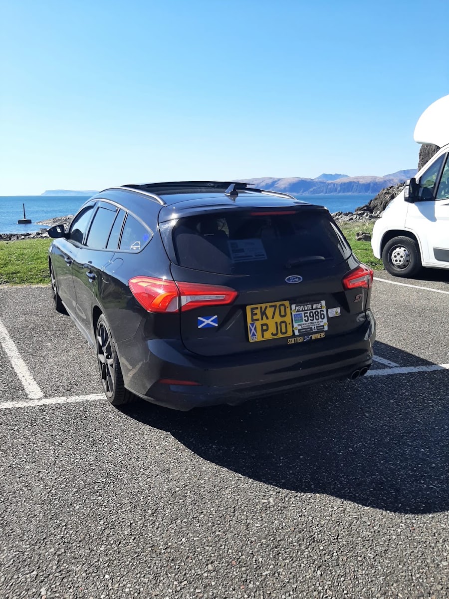 Ford Focus estate taxi parked by the coast